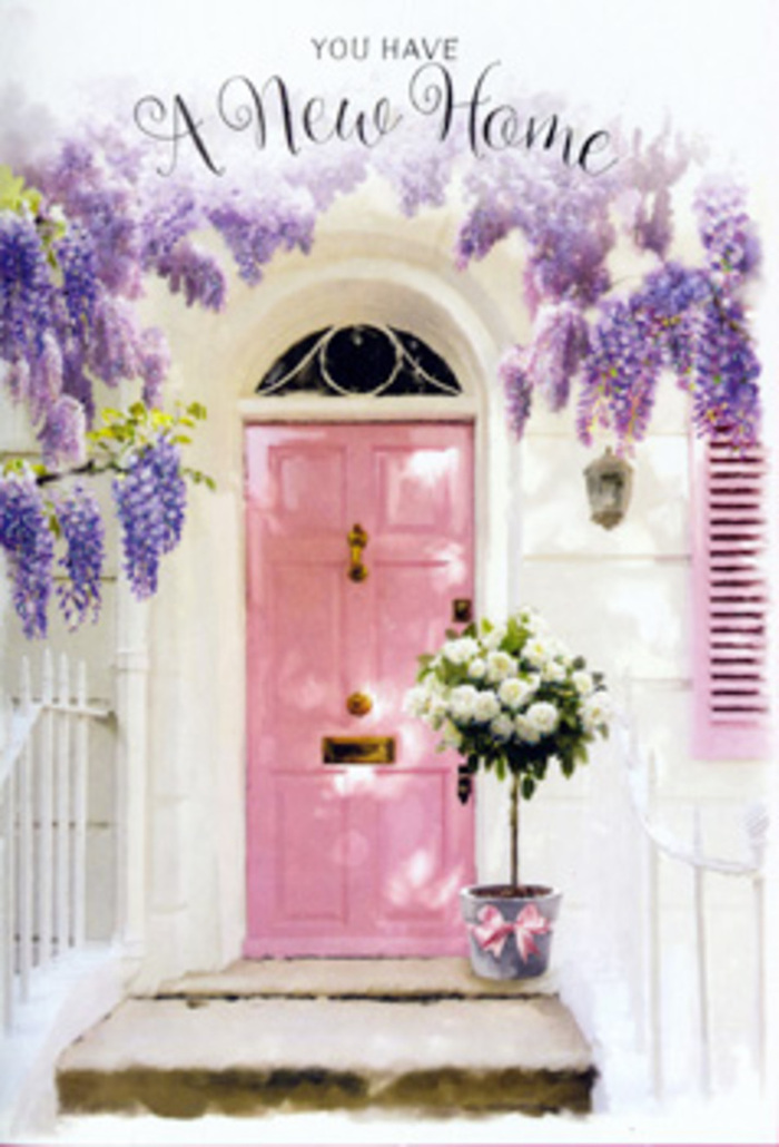 A gentle moment of new-beginning joy is frozen in this Watford doorway, where every detail seems to have been arranged to whisper welcome home. The focal point is a softly painted pink door, glowing with a warm pastel hue that immediately conveys kindness and charm. Beside it, a single shutter has been brushed in the same shade, while the surrounding whitewashed walls provide a clean, serene canvas that bounces light back onto the entrance. Overhead, wisteria spills in generous swathes of lavender and cool lilac, its dangling clusters layered and delicate, reminiscent of the plentiful blooms seen in established front gardens around Nascot Wood in late spring. These floral curtains frame the doorway like a natural archway, suggesting both celebration and shelter. On the doorstep itself sits a chic metal bucket, filled to overflowing with creamy white roses whose petals appear soft and richly layered, as if each flower has opened just enough to show its full beauty without losing its freshness. Threads of green foliage weave between the roses, adding depth, texture, and an easy, garden-like feel. Around the bucket, a blush-pink satin ribbon is tied in a simple but elegant bow, its sheen catching the ambient daylight and uniting the colour story of wisteria, door, and blooms. Soft shadows from the trailing vines dance across the step, making the arrangement feel alive and slightly in motion, even though everything is still. The impression is one of calm anticipation, the kind of floral gift a Watford resident would send to celebrate friends settling into a new house near the High Street or along peaceful residential lanes. It speaks quietly of comfort, delight, and the beginnings of future memories unfolding just beyond that pink threshold.